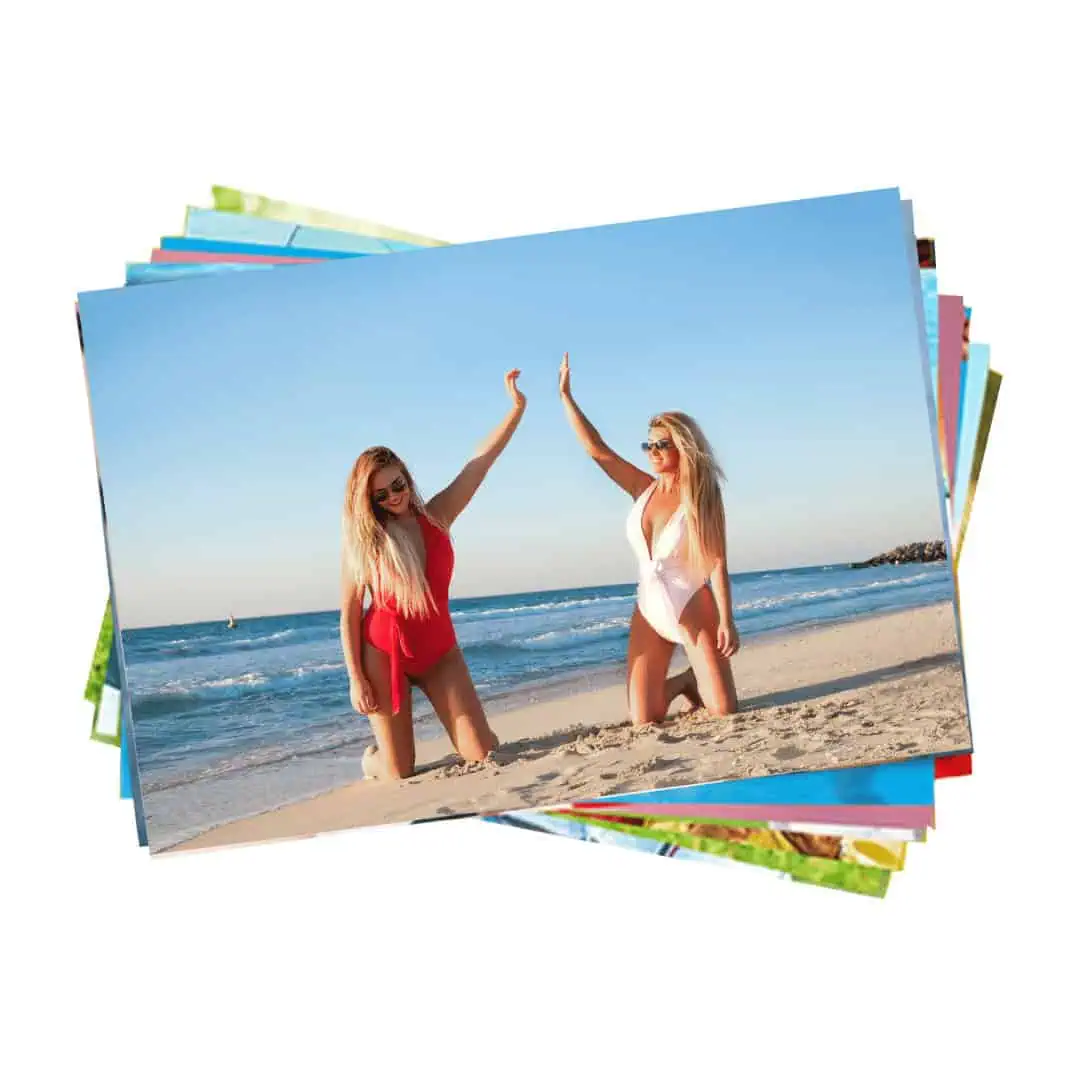 Bright women enjoying a sunny day at the beach, wearing colorful swimsuits and sunglasses.