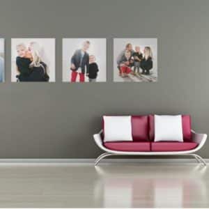 Happy family photos on grey wall with modern sofa and potted plant, stylish home interior decor.