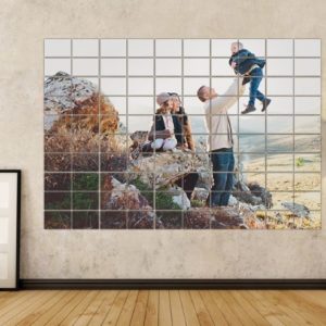Vibrant family outdoor portrait displayed on a wall art collage with black lamp in modern living room.