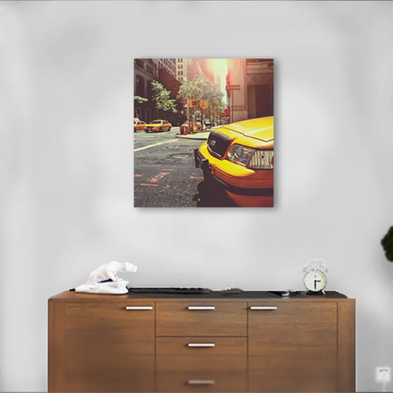 Yellow taxi cab in urban street scene with sunlight; vibrant city transportation image.