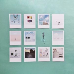 Vibrant photo prints displayed on a mint green wall, showcasing colourful themes and scenic landscapes.
