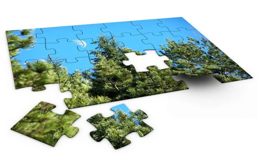 Lush green pine trees on a bright blue sky, puzzle pieces assembling nature scene, outdoor green environment, scenic landscape, eco-friendly design.