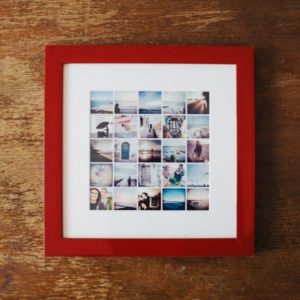 Vivid photo collage in a stylish red framed shadow box on wooden surface.