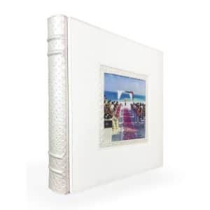 Elegant white photo album with beach wedding image cutout, perfect for memories and events.