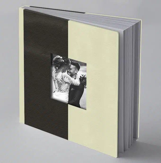 Black and white wedding photo album with textured hardcover on grey background.
